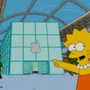 An animated character wearing an orange dress and a white pearl necklace, smiling and pointing at a large glass building with an Apple logo. Another character is seen walking in the background. The building interior has a high, curved ceiling, creating a scene reminiscent of modern TV show settings.