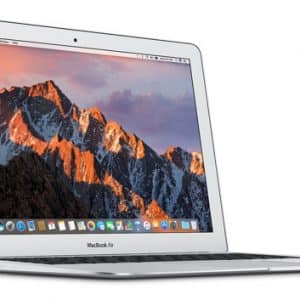 A silver MacBook Air laptop with its screen displaying a mountain landscape at sunset. The laptop is shown from a slight side angle, open and powered on, with the macOS desktop visible, including various app icons in the dock at the bottom. Exciting news: Apple plans to release a cheaper MacBook Air by the end of this year.