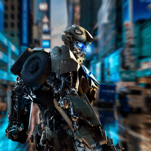 A detailed robot with blue LED lights on its eyes and components stands in a well-lit, futuristic city street filled with blurred motion effects. The robot appears to be made from various mechanical parts, including a tire on its shoulder and a multi-barreled arm cannon, perfect for an iPhone X wallpaper featured in AppleMagazine.