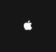 A black background features a prominent white Apple logo in the center. The logo, resembling an apple with a bite taken out of the right side and a leaf on top, is a well-known symbol of tech giant Apple Inc., now actively hiring skilled software developers.