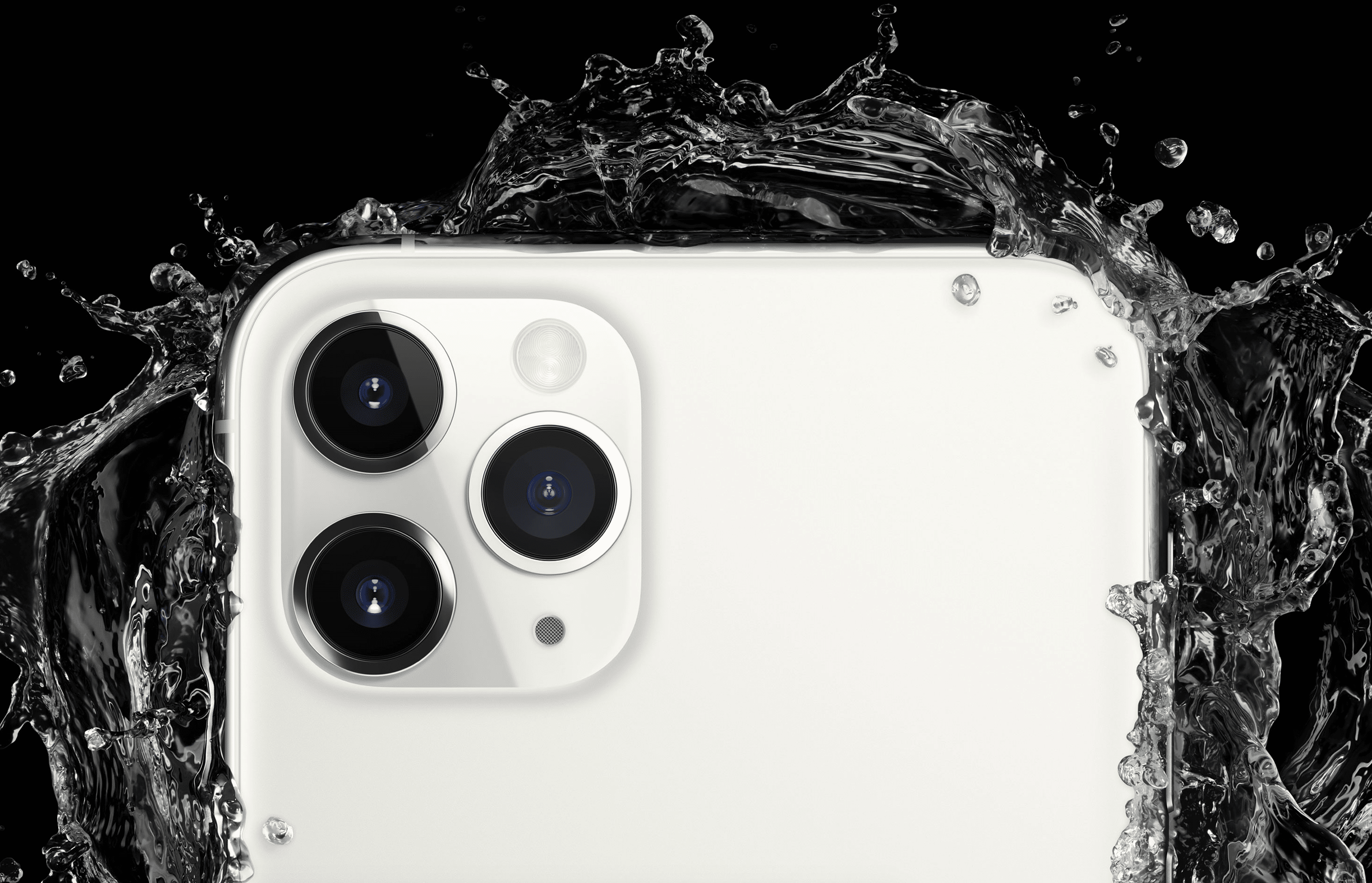 Close-up of the top corner of a white smartphone with three camera lenses. Water splashes around the phone, highlighting its water resistance feature against a black background. Despite challenges like Coronavirus affecting iPhone shipments, this model stands out with its durability.