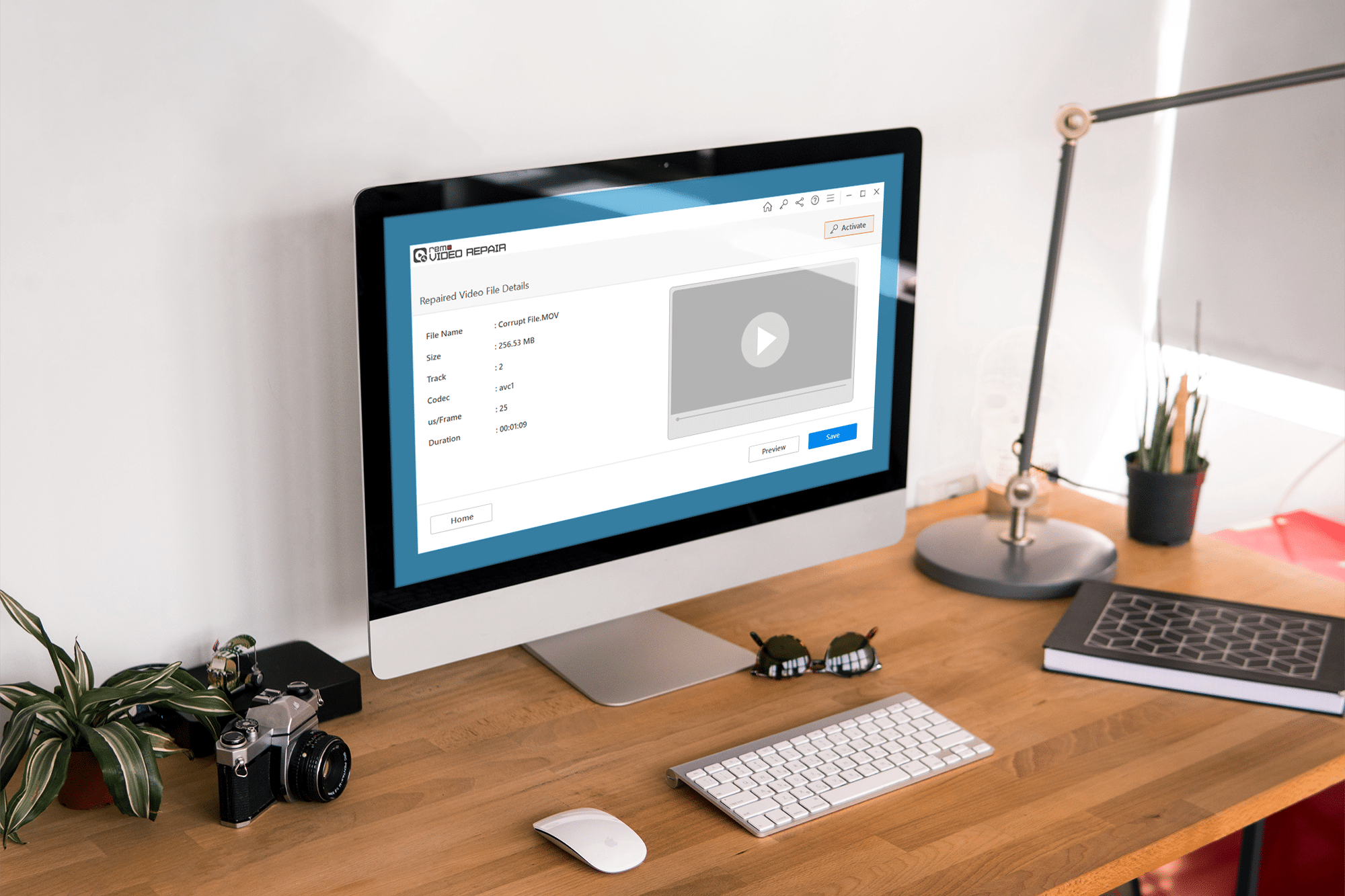 A desktop computer on a wooden desk displays a video editing software interface. Surrounding the computer are a camera, mouse, keyboard, pen, notepad, and various desk accessories. A lamp and some plants are also placed on the desk.