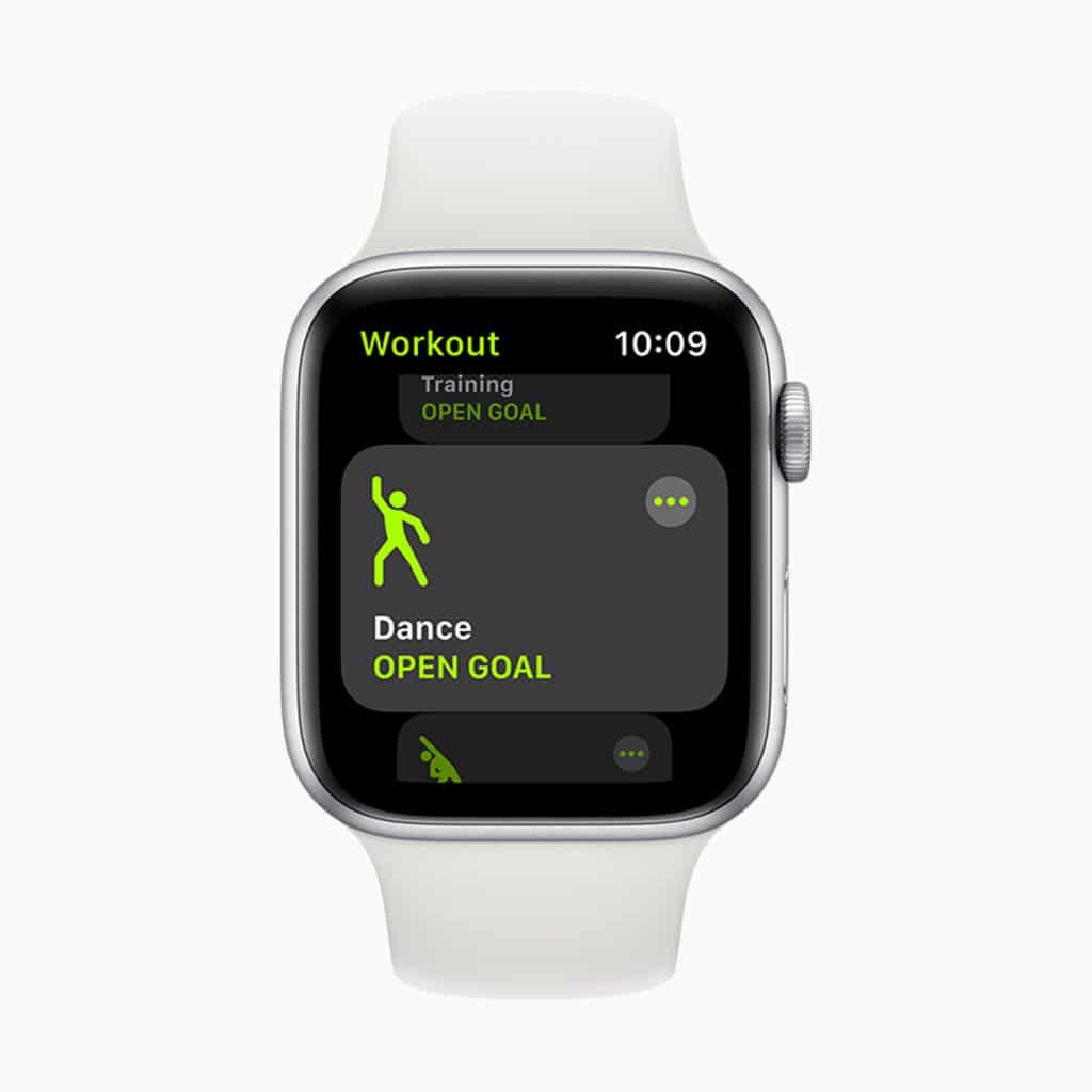 A close-up of an Apple Watch with watchOS 7 displaying the Workout app interface. The screen shows options for 'Training' and 'Dance' workouts, both labeled as 'OPEN GOAL.' The time on the watch is 10:09, and the watch has a white band.