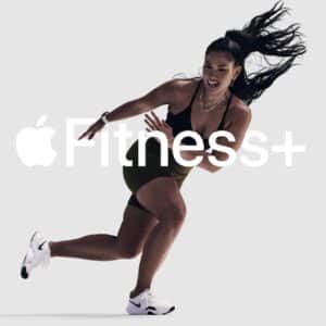 A person using Apple Fitness+ on an iPhone, with a Fitbit tracker displayed, showcasing a workout session without an Apple Watch, emphasizing Apple Fitness+ compatibility for broader device support in 2025.