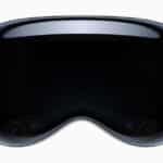 Front view of Apple Vision Pro headset with a curved glass display and integrated sensor array.