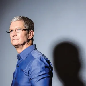 Apple iPhone and MacBook inventory stockpiled in a warehouse, highlighting the tariff-driven import surge and looming price hikes for 2025.