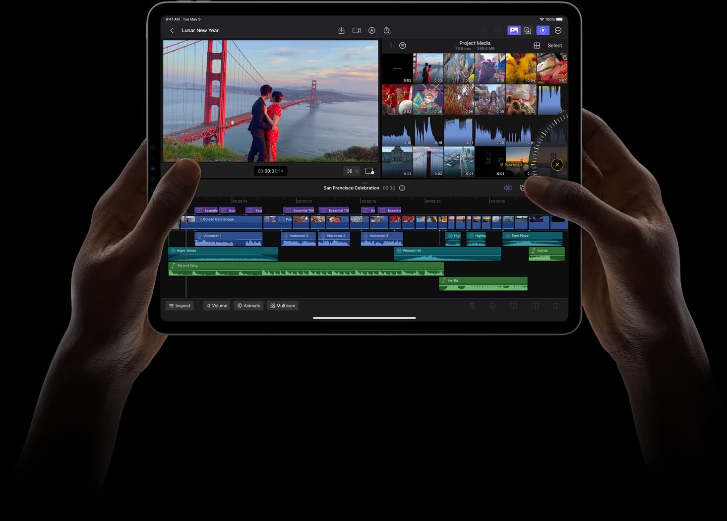 Hands holding an iPad with Final Cut Pro displayed on the screen. The software shows a video in the preview window featuring a person near the Golden Gate Bridge, with multiple video and audio tracks layered in the editing timeline below, highlighting its powerful multicam feature.