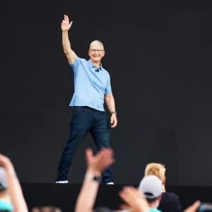 Apple iPhone and MacBook inventory stockpiled in a warehouse, highlighting the tariff-driven import surge and looming price hikes for 2025.