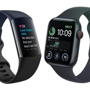 Fitbit vs. Apple Watch: The left watch, with a black band, displays a heart rate alert screen. The right watch, also with a black band, shows time, date, heart rate, activity rings, and other app icons on its screen, featuring an Apple logo in the lower right corner.
