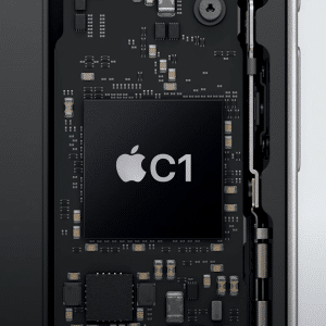 Close-up of an electronic circuit board inside a device, featuring a large black Apple C1 Modem chip at the center, labeled with "C1," and surrounded by various smaller components and connectors.