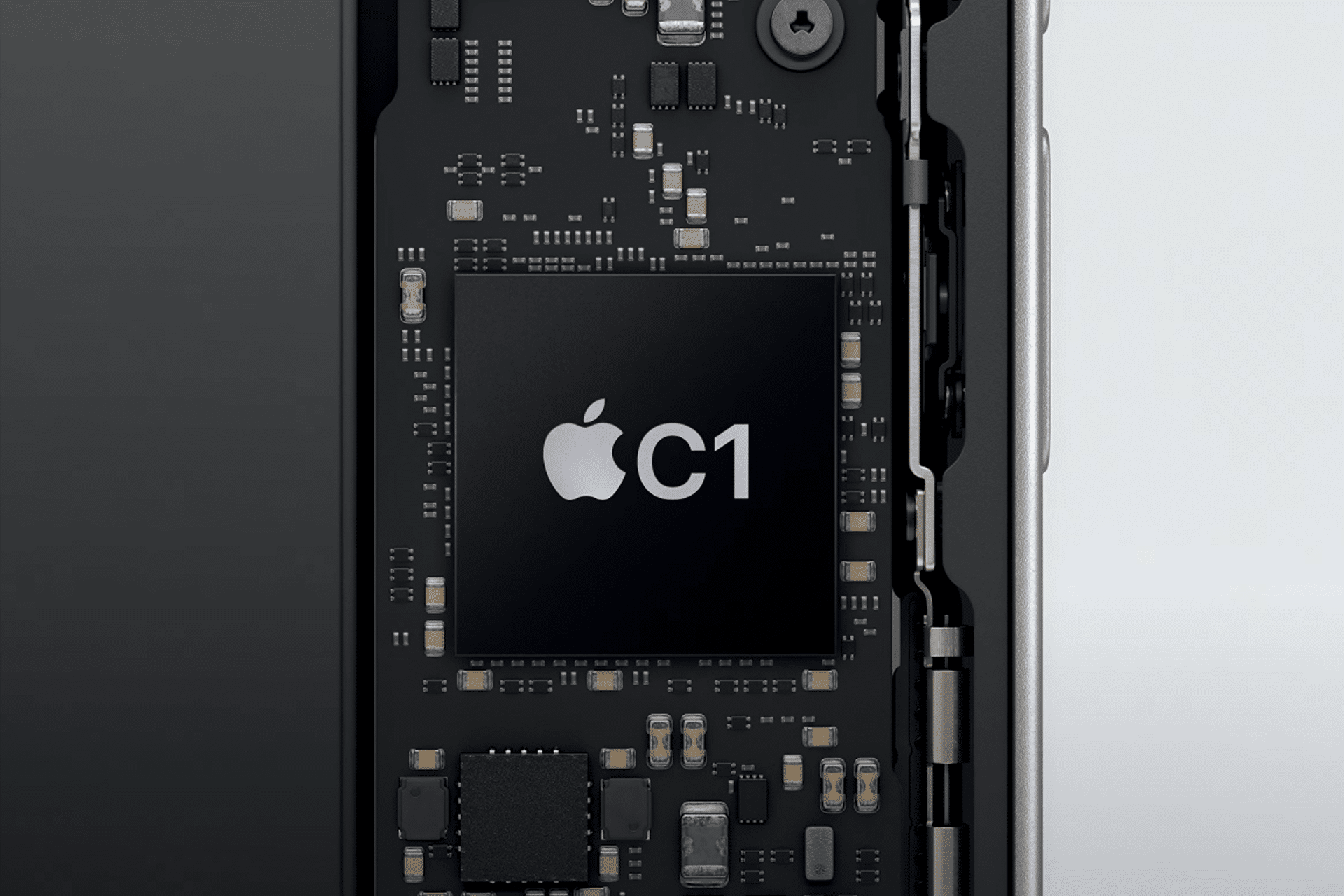 Close-up of an electronic circuit board inside a device, featuring a large black Apple C1 Modem chip at the center, labeled with "C1," and surrounded by various smaller components and connectors.