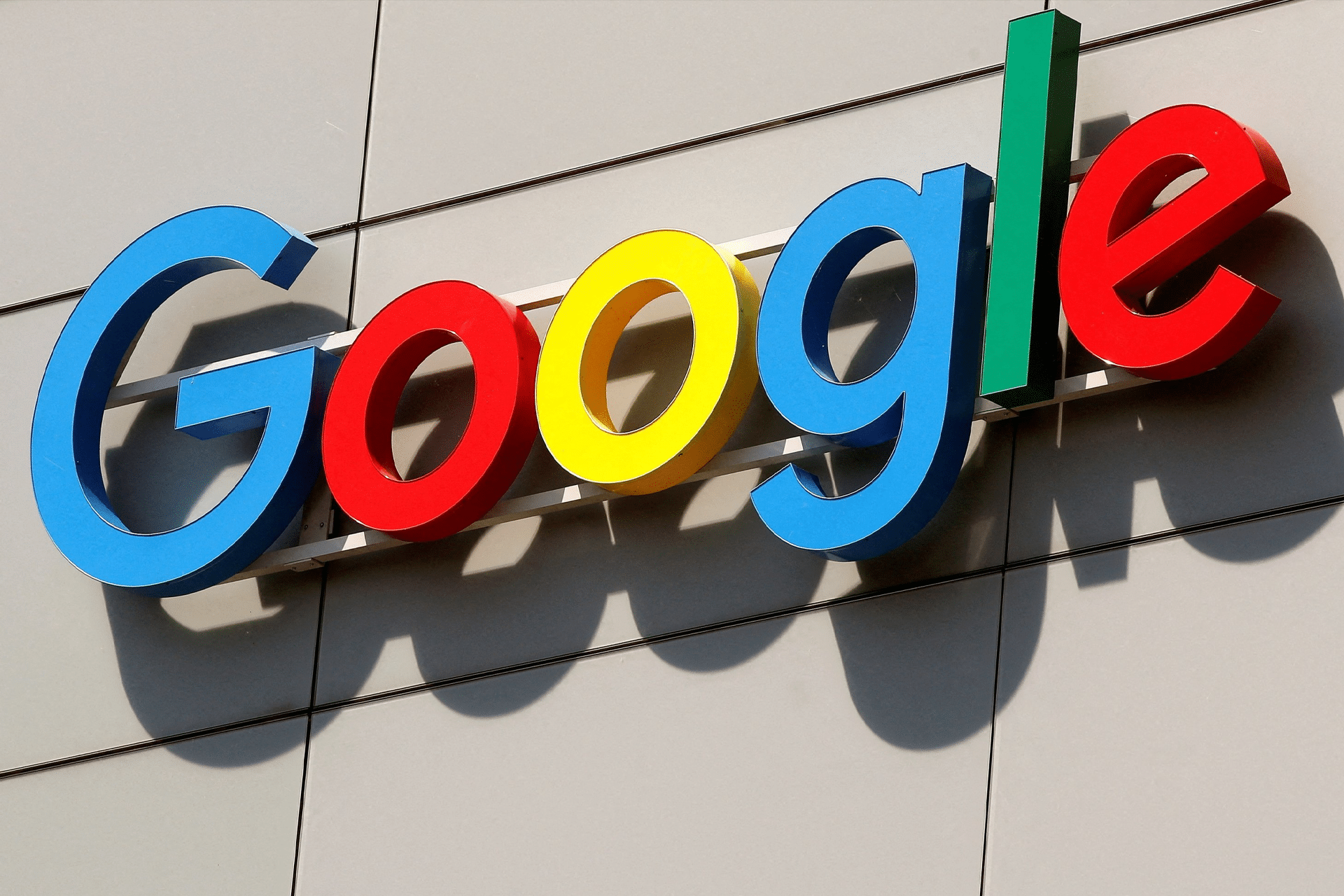 The Google logo in bright blue, red, yellow, and green letters is mounted on the exterior wall of a building with gray panels, hinting at exciting Google Gemini AI updates and features coming in 2025.