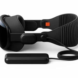 A leaked image showcases an all-black Apple Vision Pro mixed reality headset with prototype parts and an attached battery pack, connected by a cable, displayed from the side on a white background.
