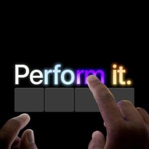 Two hands with fingers extended are about to tap a glowing, stylized "Perform it." on a black background—letters "rm" highlighted in purple, square buttons below—evoking the creative energy of Apple Creator Studio.