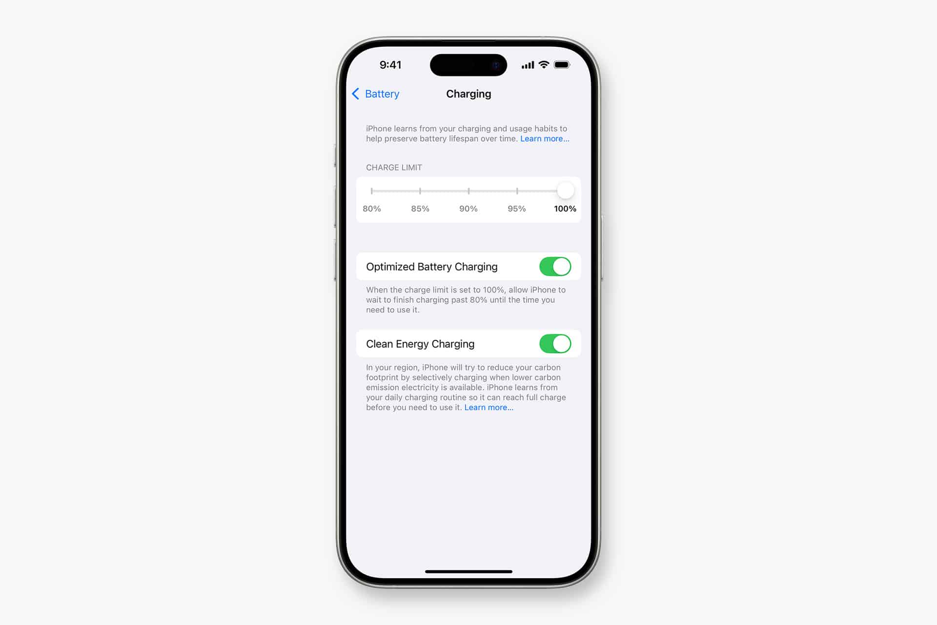 An iPhone screen displays smart charging settings with "Charge Limit" set to 100%, and toggles for "Optimized Battery Charging" and "Clean Energy Charging" both turned on.